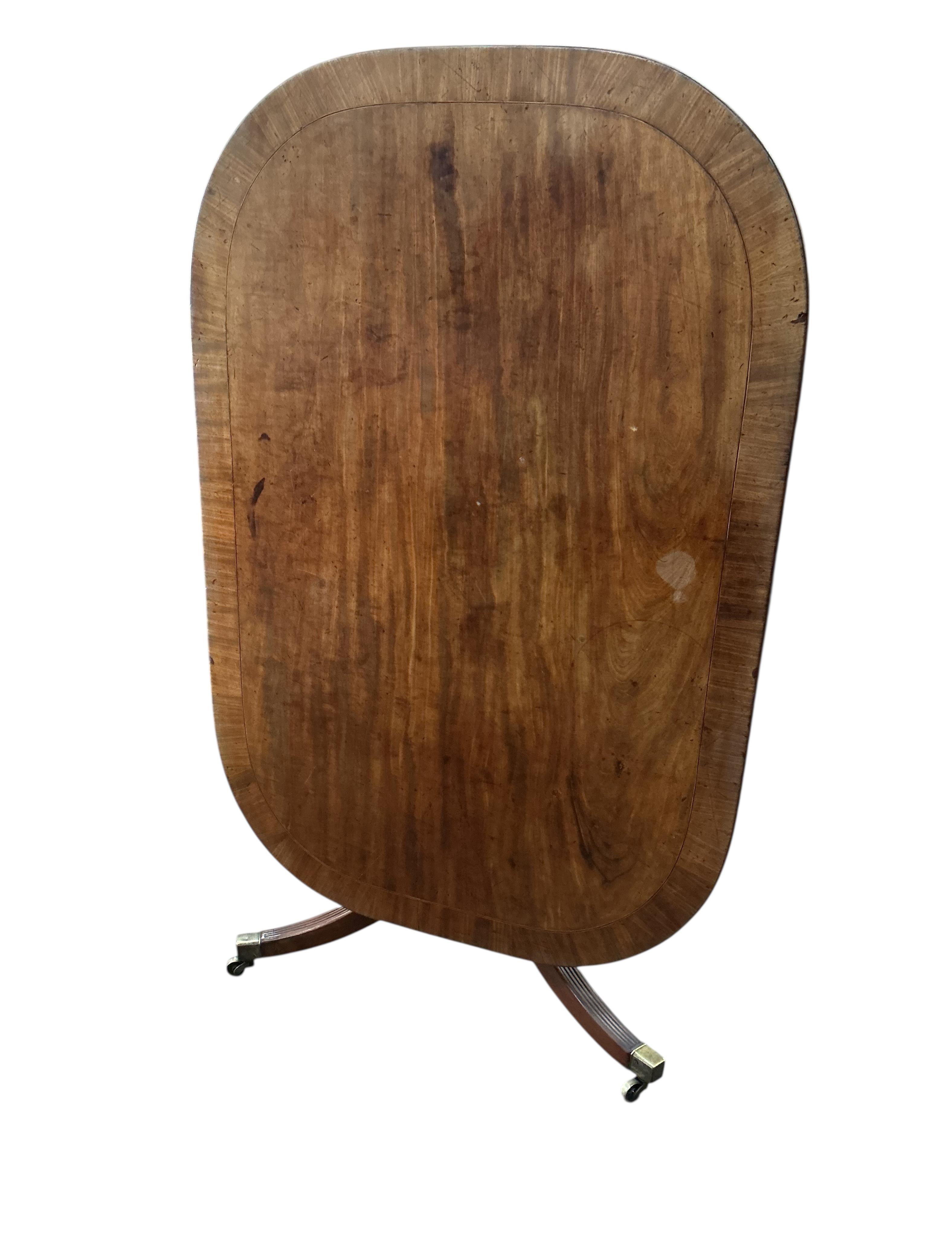 A George III mahogany rectangular tilt top dining table, width 126cm, depth 84cm, height 69cm